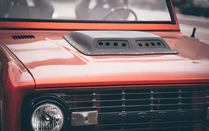 Raudonai dažytas automobilio kapotas